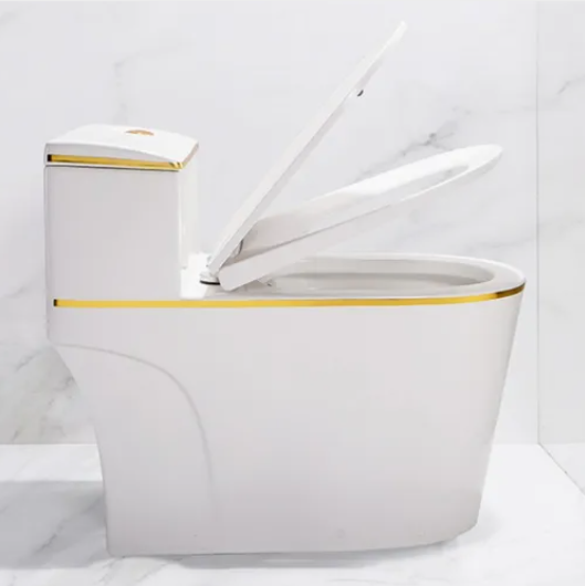Luxury white ceramic one piece toilet with gold trim, water-saving dual flush design, ideal for hotels and modern bathrooms.