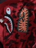 The hoodie looks very good, the quality is very good. The Bape bag, the Bape tag, the bullseye sign, the stitching, the shark face, the WGM (World Gone Mad) is stitched on good, the Bape 'ape' on the wrist sleeve has a perfect color tone even the lower Bape tag is in the perfect gold glitter tone because the older Bape hoodies also had the gold glitter tone on the lower tag so this is the older version of the red shark face hoodie which is good. Even the red Color is right and the wrist sleeves also have a perfect red color. The only negative aspect that I saw was the M on the WGM that’s stitched on the M was a little bit squished together so that you couldn’t see the purple line in the middle, but that is the only thing that I noticed negatively even though that is something that you can´t really see when you are wearing it normally. I would also consider sizing up if you want a more baggy look and if you want to zip up your hoodie completely to the top. Overall the hoodie is very good and PkStockX is a very customer friendly company and I can only recommend them, their work is just good. I will also buy again from here in the future. Thank you so much PkStockX.
