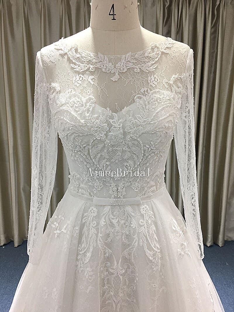 A-line Jewel neckline court train long sleeves french lace sequin bridal wedding dress gown with low-cut back.