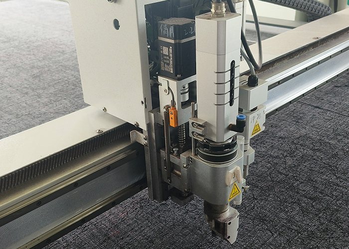 Close-up of the auto cutter head and fabric being cut to shape